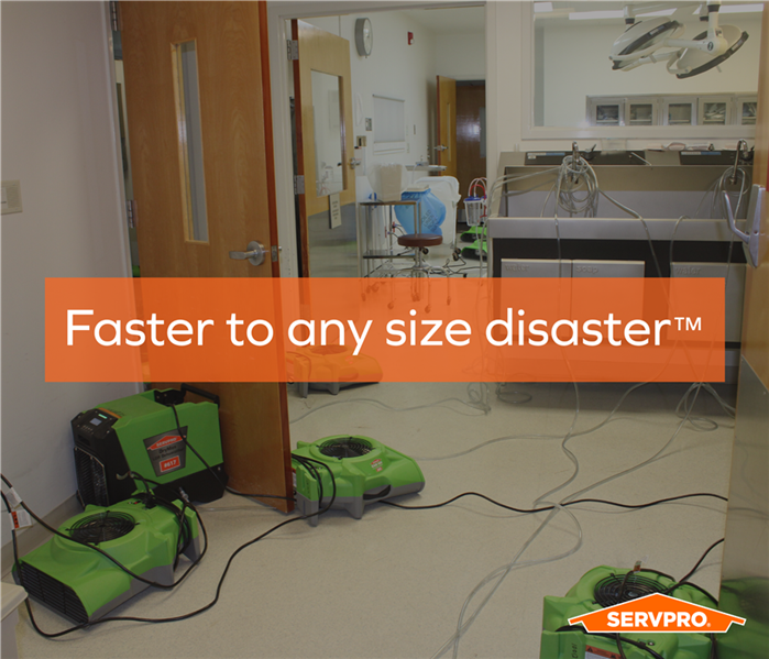 senior living facility after a pipe break, servpro air movers strewn on the floor of medical hallway, drying out the facility